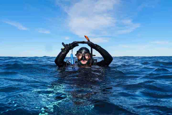 a scuba diver giving the okay signal